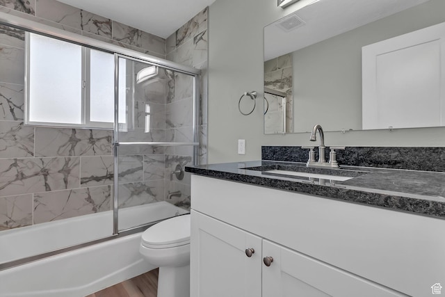 3502 W 8350 S, West Jordan, UT 84088 - full bath with vanity, bath / shower combo with glass door, toilet, visible vents, and wood finished floors