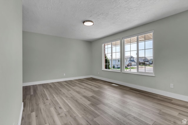 3502 W 8350 S, West Jordan, UT 84088 - empty room featuring a textured ceiling, wood finished floors, and baseboards