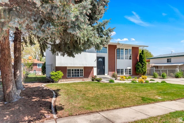 3502 W 8350 S, West Jordan, UT 84088 - raised ranch featuring fence, a front yard, and brick siding