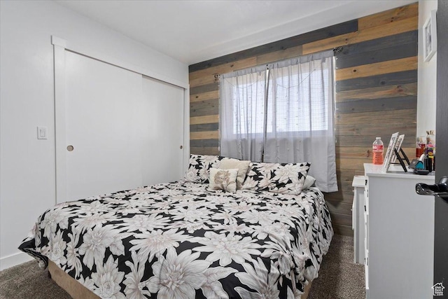 3902 W 4955 S, Taylorsville, UT 84129 - bedroom featuring wood walls, a closet, and carpet flooring