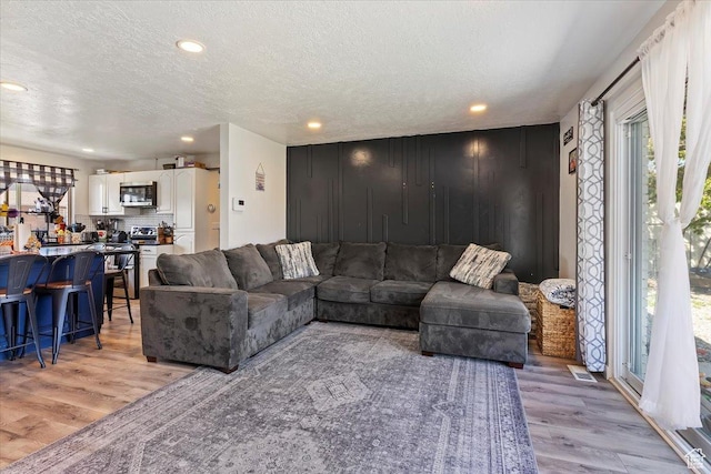 3902 W 4955 S, Taylorsville, UT 84129 - living area with recessed lighting, a textured ceiling, and light wood-type flooring