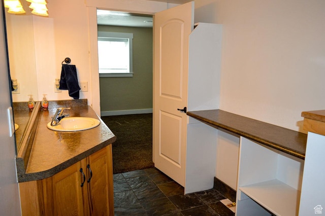 5859 E Ashley Creek Rd S, Vernal, UT 84078 - bathroom featuring vanity, stone finish floors, and baseboards