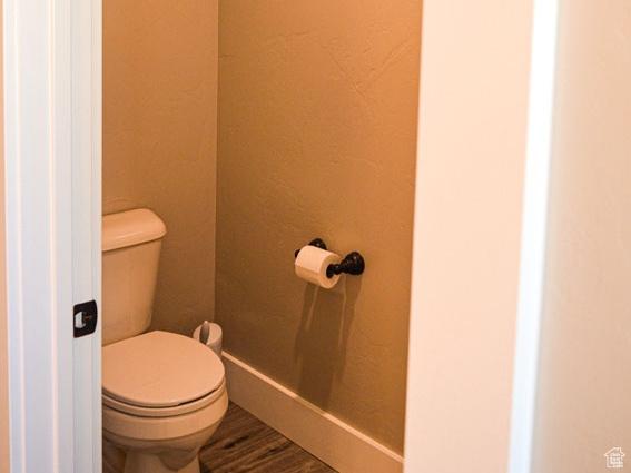 5859 E Ashley Creek Rd S, Vernal, UT 84078 - bathroom with toilet, wood finished floors, and a textured wall