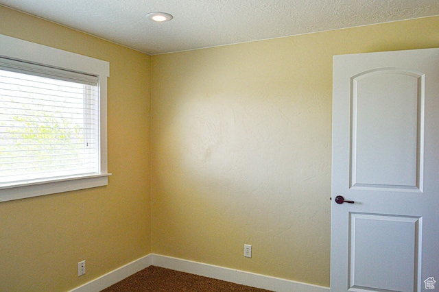 5859 E Ashley Creek Rd S, Vernal, UT 84078 - empty room featuring baseboards, plenty of natural light, and a textured ceiling