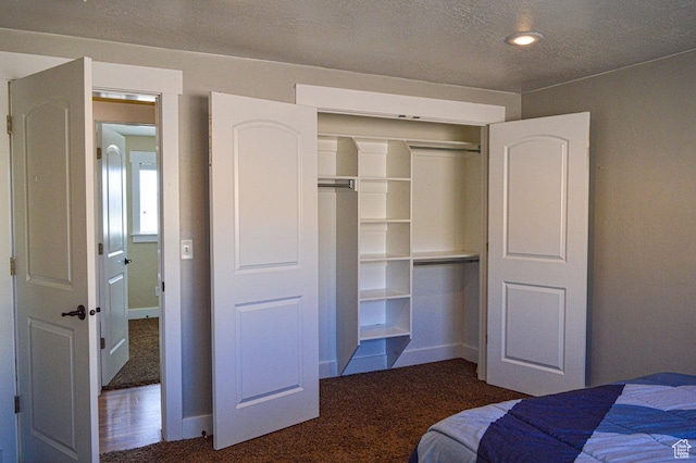 5859 E Ashley Creek Rd S, Vernal, UT 84078 - unfurnished bedroom featuring carpet flooring, a closet, baseboards, and a textured ceiling