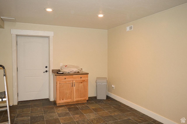 5859 E Ashley Creek Rd S, Vernal, UT 84078 - spare room with baseboards, recessed lighting, and dark stone finish floors