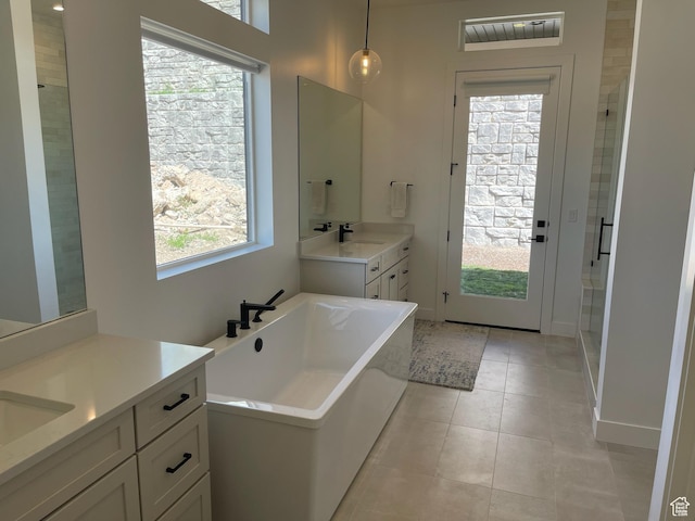 889 S Winter Ln, North Salt Lake, UT 84054 - bathroom with a freestanding tub, tile patterned flooring, a stall shower, two vanities, and a sink