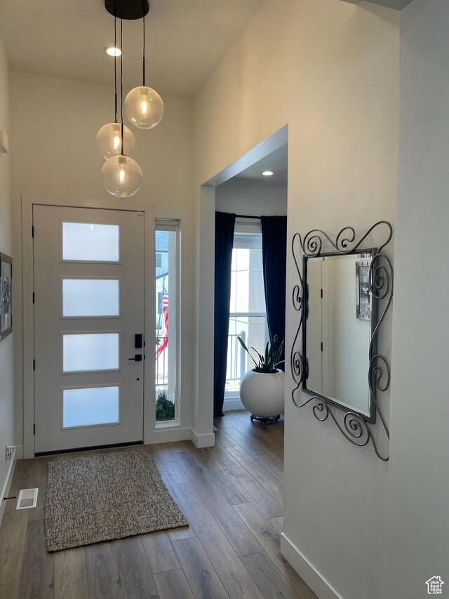 889 S Winter Ln, North Salt Lake, UT 84054 - entrance foyer with baseboards, a high ceiling, wood finished floors, and visible vents