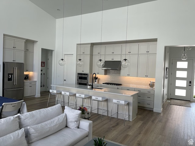 889 S Winter Ln, North Salt Lake, UT 84054 - kitchen with a high ceiling, a sink, high end refrigerator, open floor plan, and under cabinet range hood