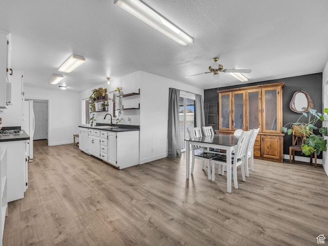 295 S 200 W, Delta, UT 84624 - kitchen with dark countertops, open shelves, a sink, a ceiling fan, and white cabinetry