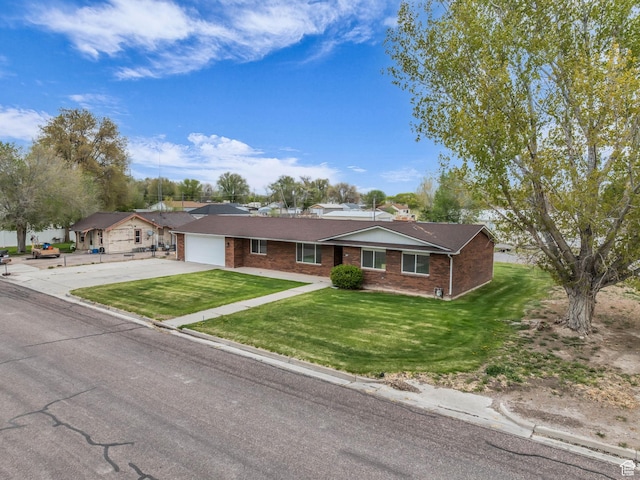 295 S 200 W, Delta, UT 84624 - ranch-style house featuring concrete driveway, brick siding, a front yard, and a garage