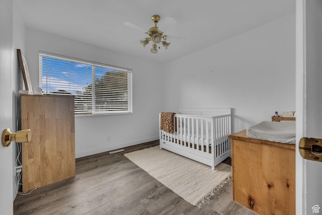 295 S 200 W, Delta, UT 84624 - bedroom with a nursery area, ceiling fan, and wood finished floors