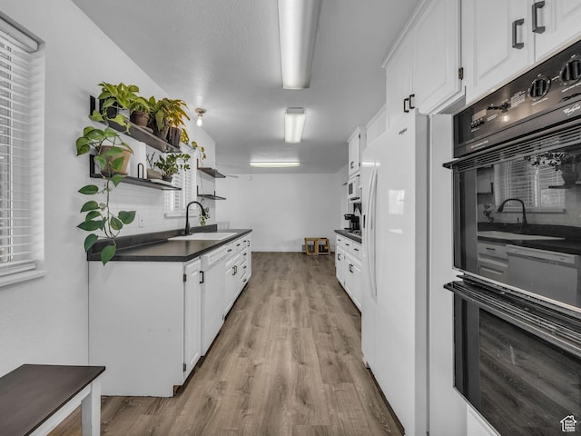295 S 200 W, Delta, UT 84624 - kitchen featuring dobule oven black, open shelves, dark countertops, white cabinetry, and a sink