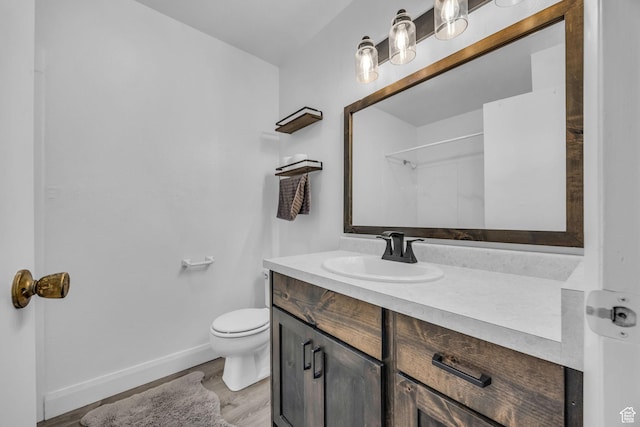 295 S 200 W, Delta, UT 84624 - bathroom with toilet, baseboards, wood finished floors, and vanity