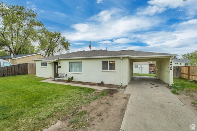 4826 S 4860 W, Salt Lake City, UT 84118 - rear view of house featuring fence, an attached carport, a shingled roof, concrete driveway, and a yard