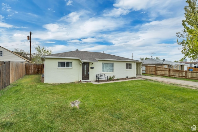 4826 S 4860 W, Salt Lake City, UT 84118 - rear view of house featuring a fenced backyard, a yard, and a shingled roof