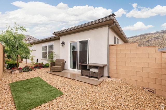 1427 N Rustico Dr, Washington, UT 84780 - back of house with stucco siding, fence, and a patio