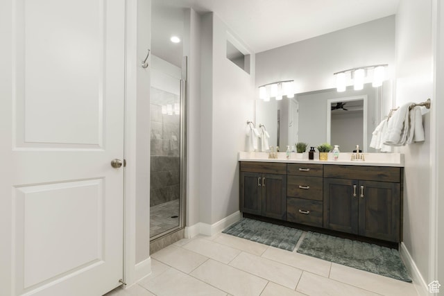 1427 N Rustico Dr, Washington, UT 84780 - bathroom featuring a shower stall, double vanity, baseboards, tile patterned flooring, and ceiling fan