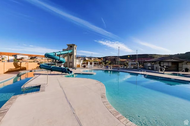 1427 N Rustico Dr, Washington, UT 84780 - community pool with a water slide, a jacuzzi, and a patio