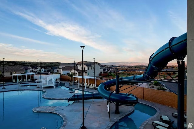 1427 N Rustico Dr, Washington, UT 84780 - community pool with a water slide and fence