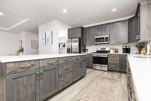 1427 N Rustico Dr, Washington, UT 84780 - kitchen with appliances with stainless steel finishes, light wood-style flooring, light countertops, recessed lighting, and a sink