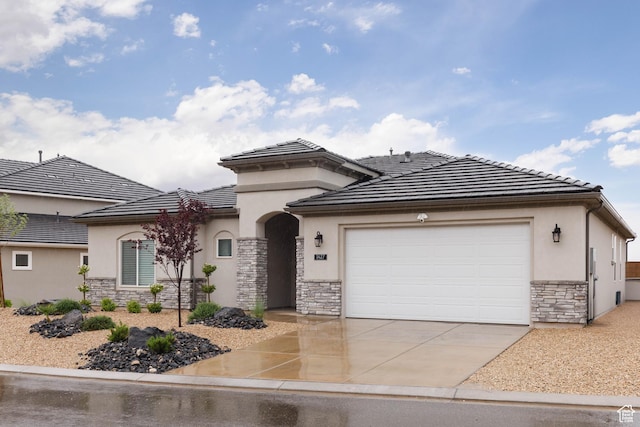 1427 N Rustico Dr, Washington, UT 84780 - view of front facade featuring stone siding, stucco siding, concrete driveway, an attached garage, and a tiled roof