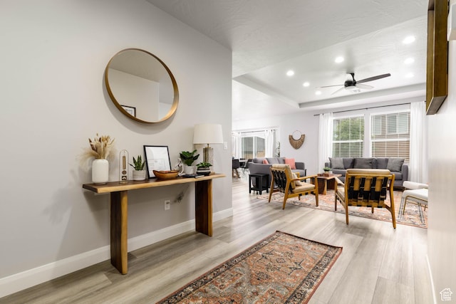 1427 N Rustico Dr, Washington, UT 84780 - interior space featuring light wood-type flooring, a raised ceiling, recessed lighting, ceiling fan, and baseboards