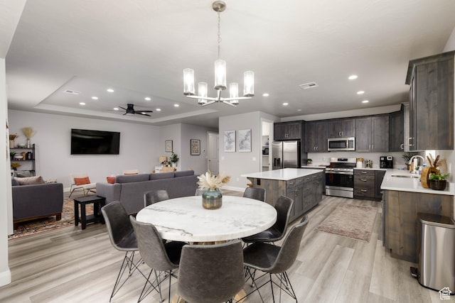 1427 N Rustico Dr, Washington, UT 84780 - dining room with a chandelier, ceiling fan, light wood-type flooring, recessed lighting, and a raised ceiling