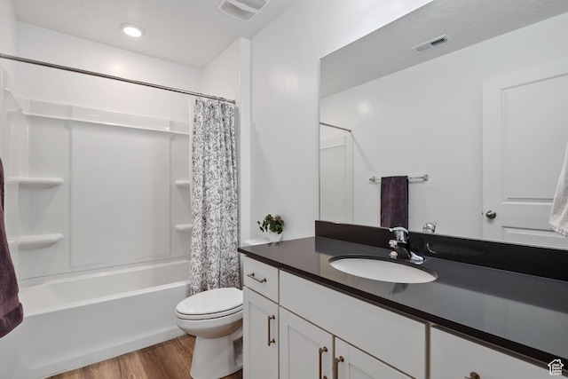 full bath featuring wood finished floors, visible vents, toilet, and vanity