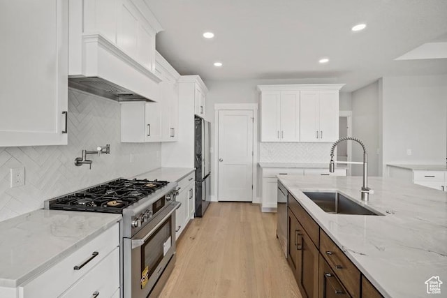 2275 E Meadowlark Ln N, North Logan, UT 84341 - kitchen with stainless steel appliances, backsplash, white cabinets, and a sink