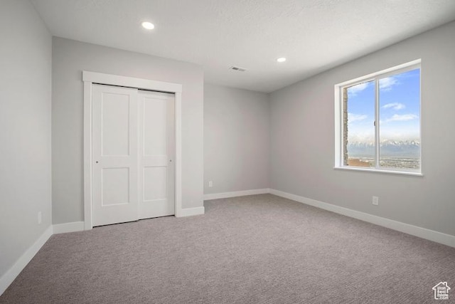 2275 E Meadowlark Ln N, North Logan, UT 84341 - unfurnished bedroom with recessed lighting, carpet flooring, a closet, visible vents, and baseboards