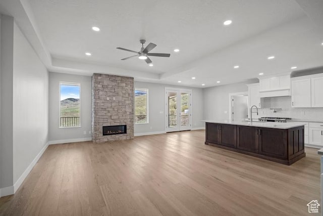 2275 E Meadowlark Ln N, North Logan, UT 84341 - kitchen with a healthy amount of sunlight, light countertops, a ceiling fan, and baseboards