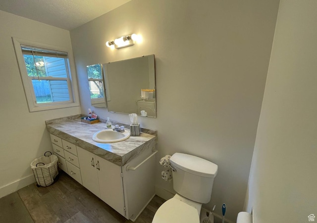 280 N Main St, Smithfield, UT 84335 - bathroom featuring vanity, toilet, baseboards, a textured ceiling, and wood finished floors