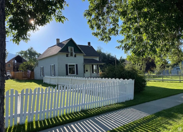 280 N Main St, Smithfield, UT 84335 - view of front of home featuring a chimney, fence private yard, and a front yard
