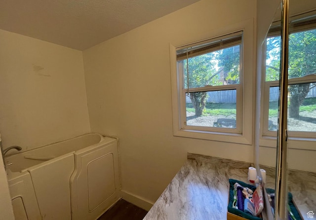 280 N Main St, Smithfield, UT 84335 - clothes washing area featuring dark wood-type flooring, plenty of natural light, and baseboards
