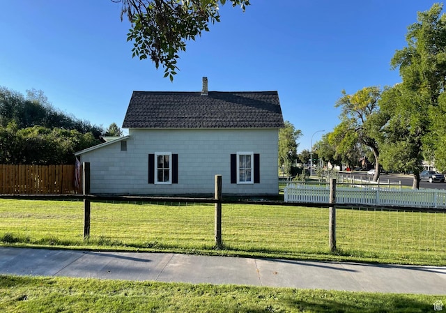 280 N Main St, Smithfield, UT 84335 - view of side of home featuring fence, a chimney, a lawn, and a shingled roof