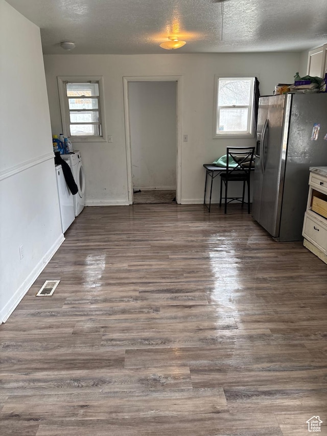 280 N Main St, Smithfield, UT 84335 - unfurnished dining area featuring a textured ceiling, washing machine and dryer, visible vents, baseboards, and dark wood finished floors
