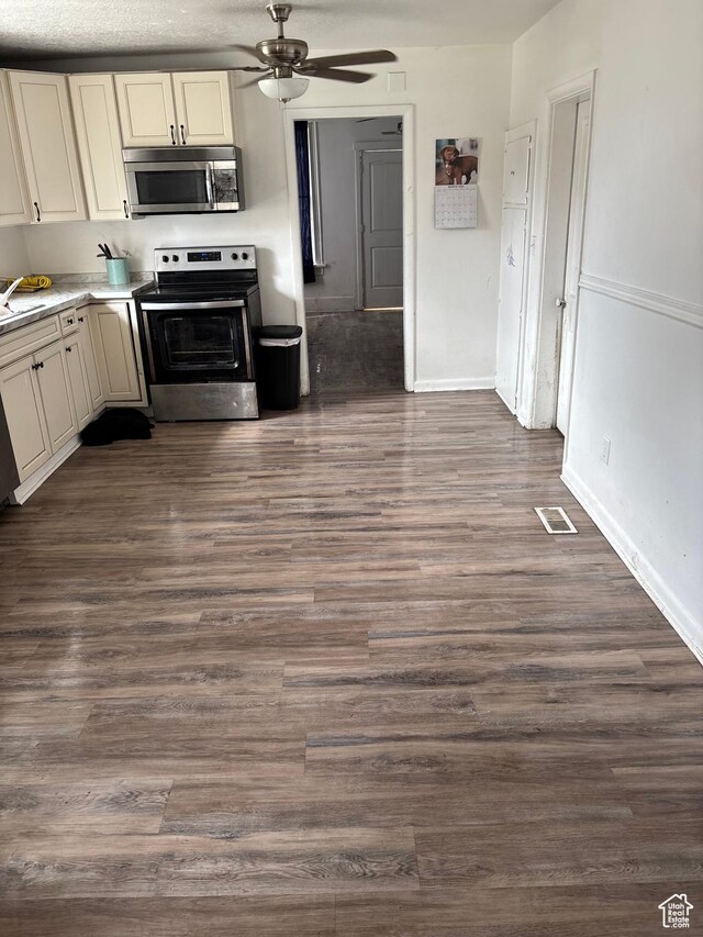 280 N Main St, Smithfield, UT 84335 - kitchen with cream cabinetry, ceiling fan, stainless steel appliances, and dark wood-style flooring