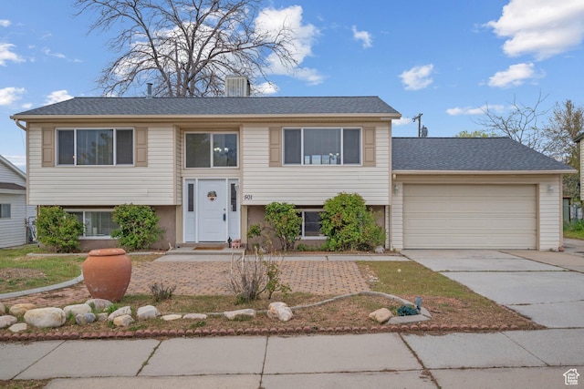 501 Valley View Dr, Tooele, UT 84074 - split foyer home with concrete driveway and an attached garage