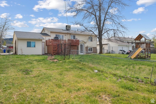 501 Valley View Dr, Tooele, UT 84074 - back of house with a deck, fence, a playground, and a lawn