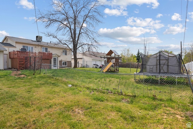 501 Valley View Dr, Tooele, UT 84074 - view of yard featuring a deck, a trampoline, a fenced backyard, and a playground