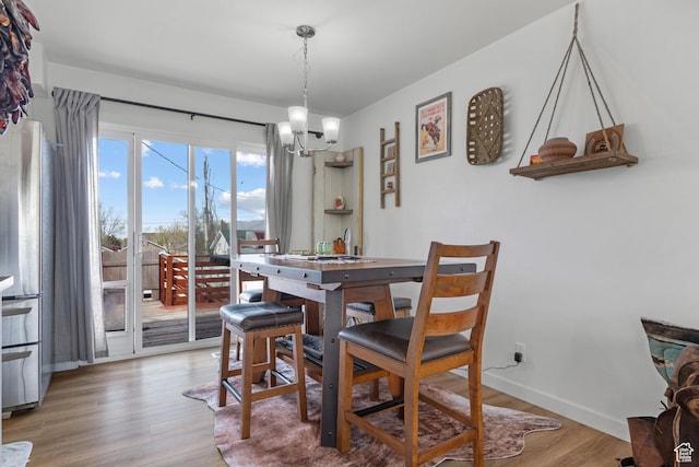501 Valley View Dr, Tooele, UT 84074 - dining area with an inviting chandelier, baseboards, and light wood-type flooring