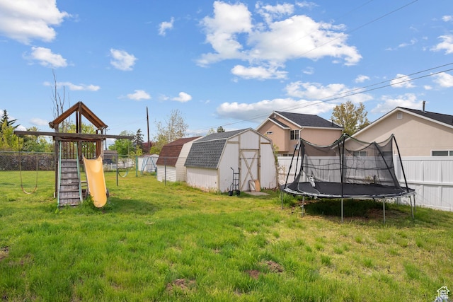 501 Valley View Dr, Tooele, UT 84074 - view of yard featuring a trampoline, fence, an outbuilding, a shed, and a playground