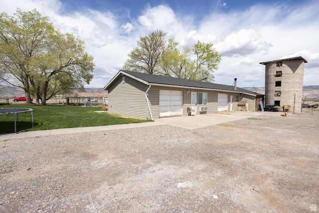 815 S Annabella Rd, Richfield, UT 84701 - exterior space with a trampoline, a front yard, driveway, and an attached garage