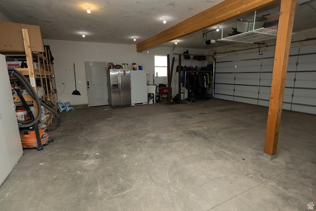 815 S Annabella Rd, Richfield, UT 84701 - garage with stainless steel refrigerator with ice dispenser, freestanding refrigerator, and a garage door opener