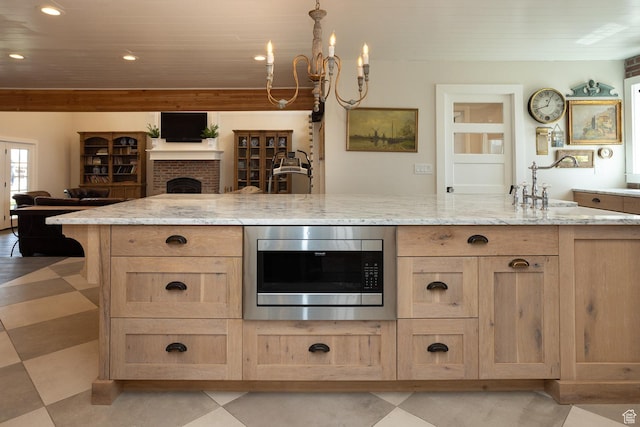 815 S Annabella Rd, Richfield, UT 84701 - kitchen featuring recessed lighting, light stone counters, light brown cabinetry, stainless steel microwave, and open floor plan