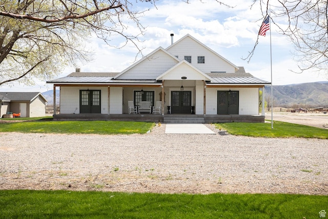 815 S Annabella Rd, Richfield, UT 84701 - modern farmhouse style home featuring a front lawn, a standing seam roof, metal roof, covered porch, and french doors