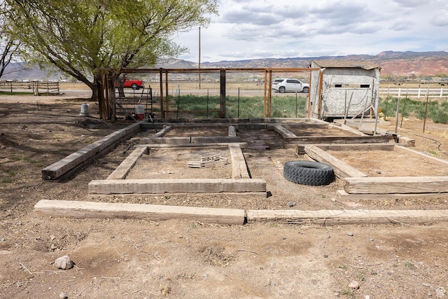 815 S Annabella Rd, Richfield, UT 84701 - view of yard with fence, a vegetable garden, and a mountain view