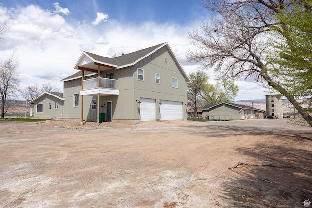 815 S Annabella Rd, Richfield, UT 84701 - view of home's exterior with board and batten siding, dirt driveway, a balcony, and an attached garage