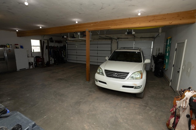 815 S Annabella Rd, Richfield, UT 84701 - garage with stainless steel fridge, freestanding refrigerator, and a garage door opener